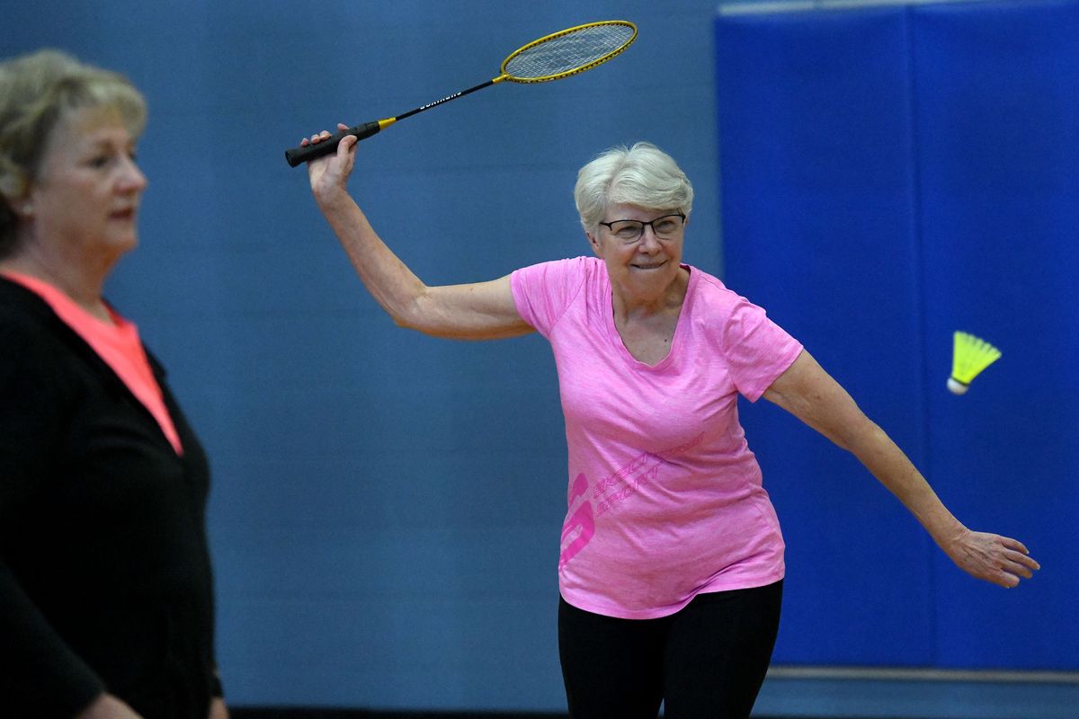 At right: Susan English eyes a shot next to Arnie Saddler during their weekly game of badminton at Focused Fitness Community Center in Spokane Valley on Wednesday.  (Kathy Plonka/The Spokesman-Review)