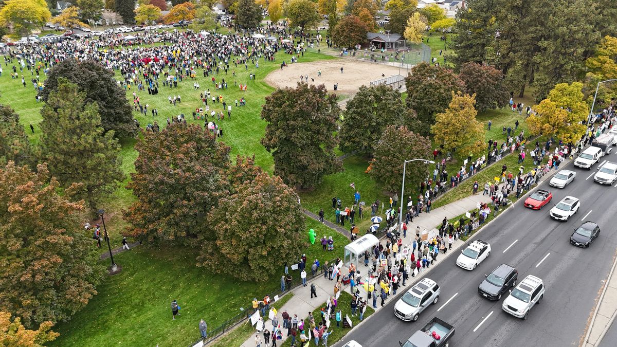 Southbound traffic on Division Street slows as it passes by crowd the from the No Kings rally at nearby B.A. Clark Park on Saturday in Spokane. Thousands gathered in the park itself while others stayed on the sidewalk. Toward the end of the rally, the crowd spread out along Division to wave signs and wave at cars.  (Jesse Tinsley/THE SPOKESMAN-REVI)
