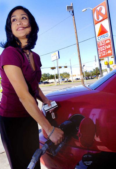 
Erika Garcia fills up earlier this month at a station in Harlingen, Texas, where gas was selling for $1.92 a gallon. Improving your vehicle's fuel efficiency can save money at the pump this holiday season.
 (AP Photo / The Spokesman-Review)