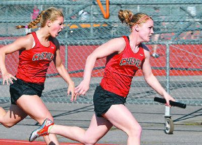 
Cheney's Annika Swenson, left, implores cousin Amanda Swenson to earn the win in the final leg of the girls 4x100 meters final. 
 (Dan Pelle / The Spokesman-Review)