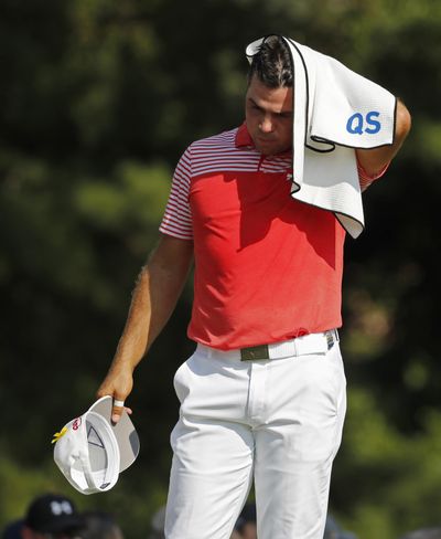 Gary Woodland wipes his head with a towel on the16th tee during the second round of the PGA Championship golf tournament at Bellerive Country Club, Friday, Aug. 10, 2018, in St. Louis. (Jeff Roberson / Associated Press)