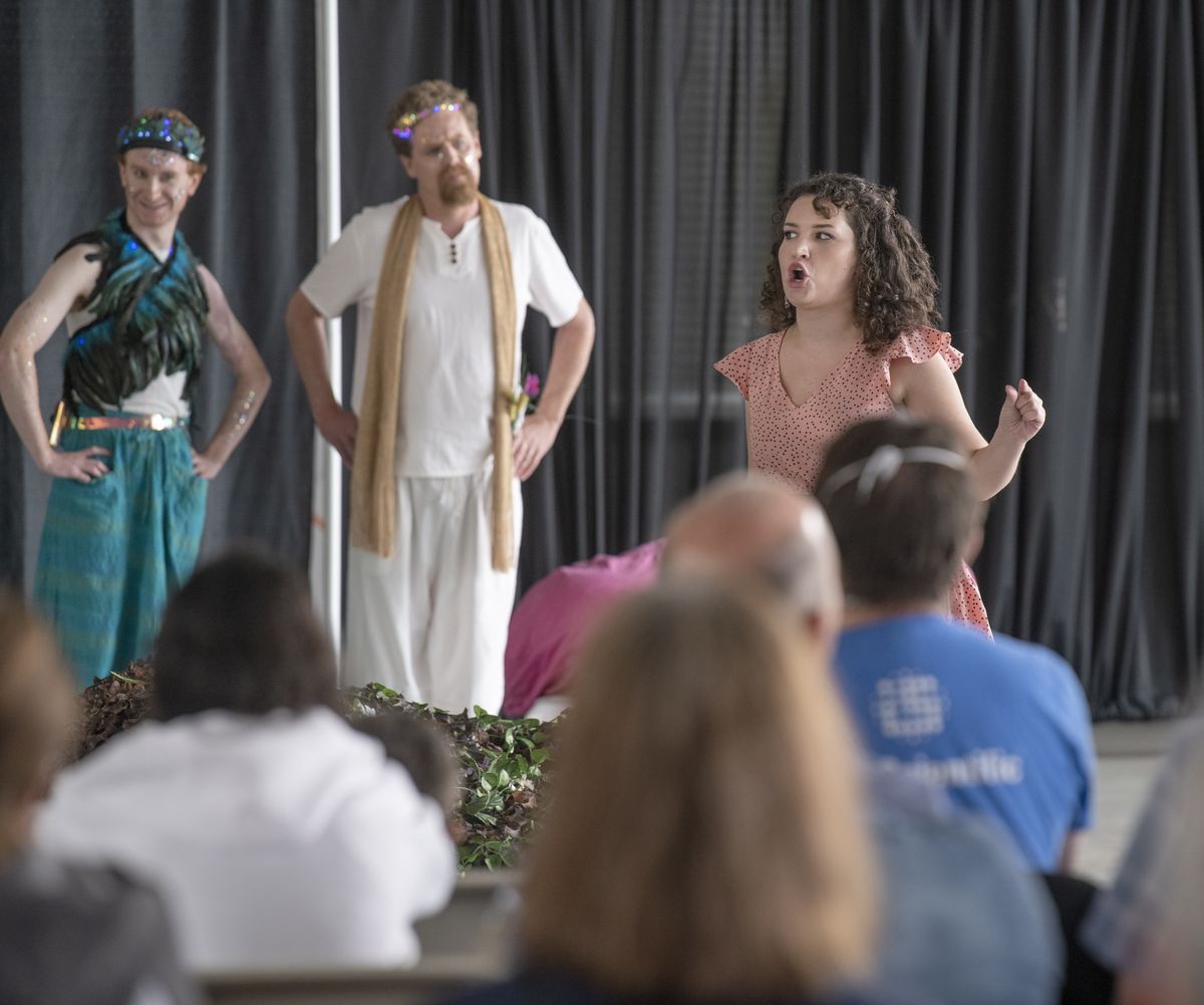 Hermia, played by Sarah Plumb, proclaims her dislike for Helena as Puck and Oberon, played by Jared McDougall and Craig Hirt, look on in the the production of “Midsummer’s Night’s Dream” in the Pavilion in Riverfront Park Sunday, Aug. 8, 2021. The play was supposed to be outdoors, but wind and rain threatened and it was moved indoors.  (Jesse Tinsley/THE SPOKESMAN-REVIEW)