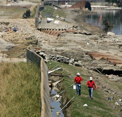 
Works continue on the breach in the Industrial Canal levee Wednesday in New Orleans. The storm surge created by Hurricane Rita eroded repairs made after Katrina and sent water surging back into the already devastated Ninth Ward. 
 (Associated Press / The Spokesman-Review)