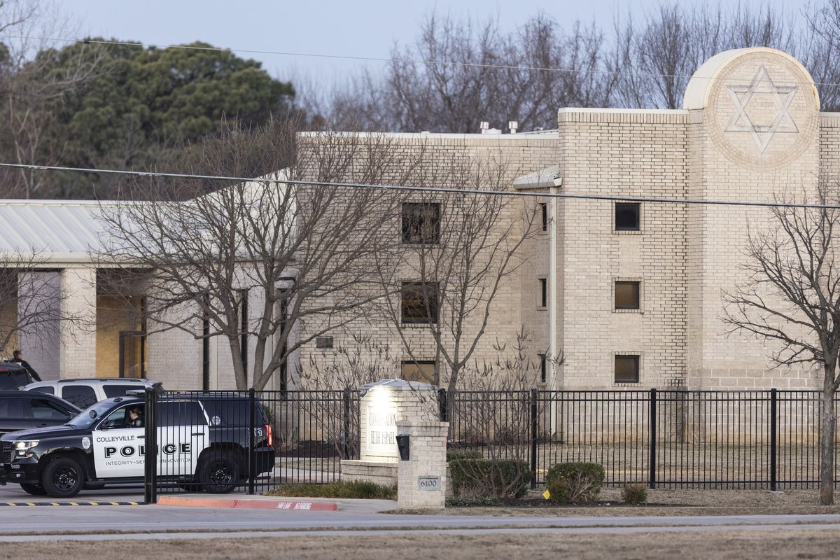 Police stand in front of the Congregation Beth Israel synagogue, Sunday, Jan. 16, 2022, in Colleyville, Texas. A man held hostages for more than 10 hours Saturday inside the temple. The hostages were able to escape and the hostage taker was killed. FBI Special Agent in Charge Matt DeSarno said a team would investigate "the shooting incident." (Brandon Wade)