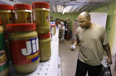Saad Hopkins, entering the University of Washington as a junior in the fall, gets groceries at the University District Food Bank  on July 15. Associated Press photos (Associated Press photos / The Spokesman-Review)