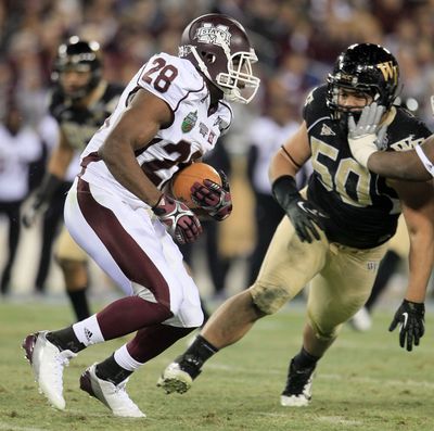 Mississippi State’s Vick Ballard gets past Wake Forest’s Nikita Whitlock on a 60-yard TD run. (Associated Press)