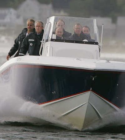 
President Bush, second from the left, rides with Russian President Vladimir Putin, center, and former President George H.W. Bush on a fishing boat Sunday.Associated Press photos
 (Associated Press photos / The Spokesman-Review)