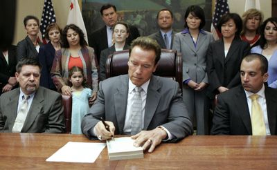 Gov. Arnold Schwarzenegger signs California’s revised budget Tuesday after using his line-item veto to impose nearly $500 million in spending cuts.  (Associated Press / The Spokesman-Review)