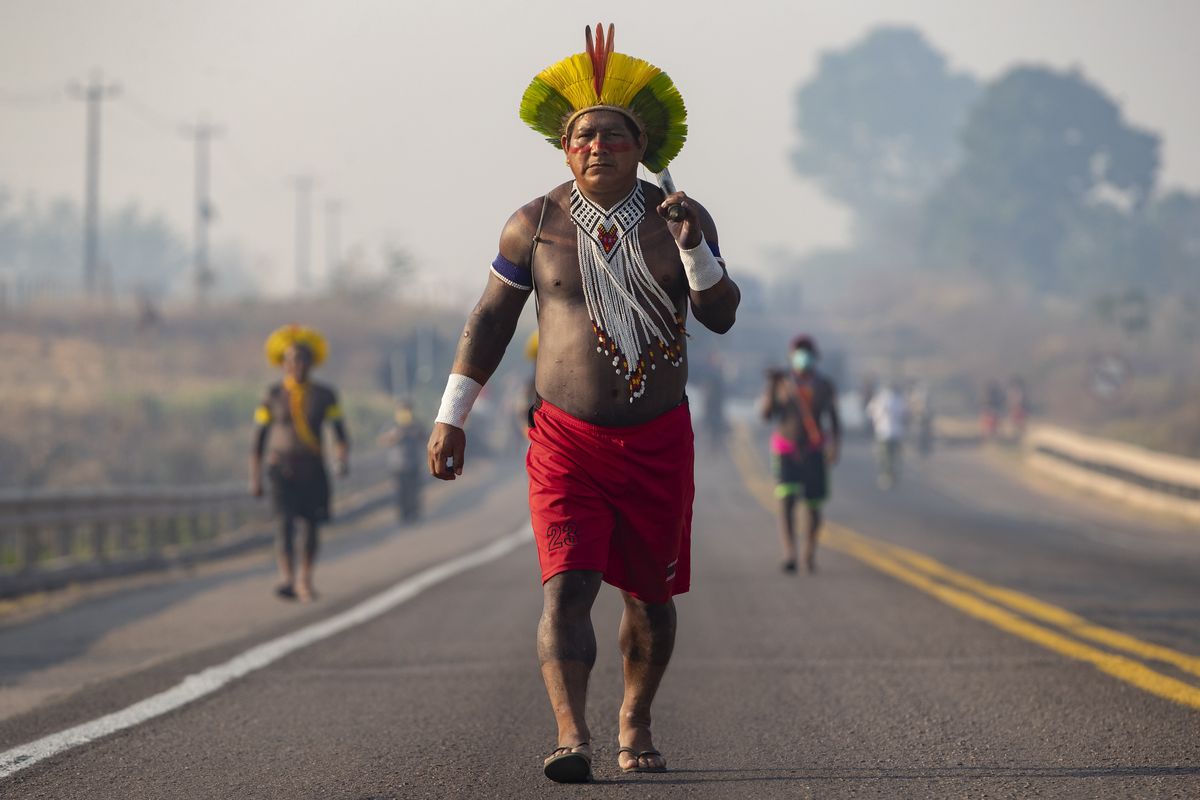Kayapo Indigenous block a highway near Novo Progresso, Para state, Brazil, Monday, Aug. 17, 2020. Protesters blocked the highway BR-163 to pressure Brazilian President Jair Bolsonaro to better shield them from COVID-19, to extend damages payments for road construction near their land, and to consult them on a proposed railway to transport soybeans and corn.  (Andre Penner)