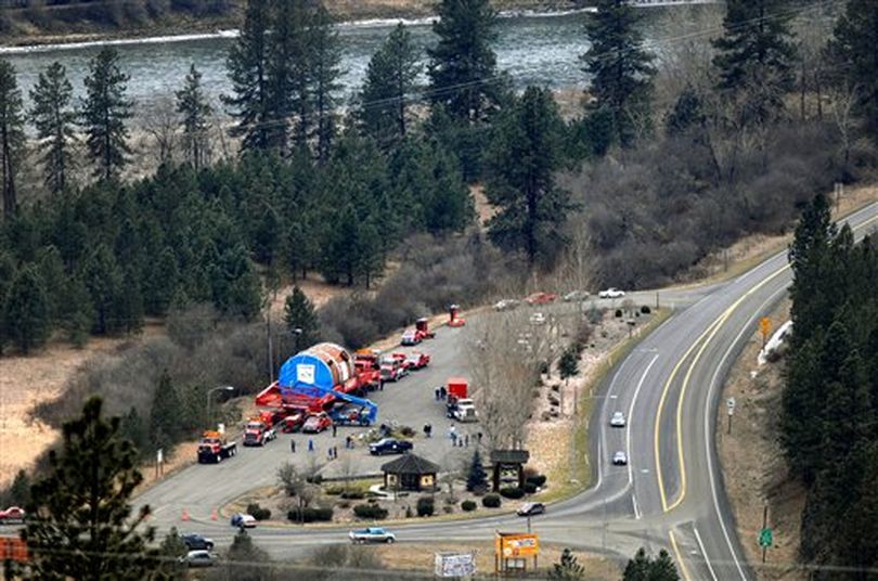 In this Thursday, Feb. 3, 2011 photo, parked between the Clearwater River and U.S. Highway 12 at Kooskia, Idaho, the first megaload of a ConocoPhillips half-drum awaits its third leg of its journey across Idaho to a refinery at Billings, Mont. Snowfall expected at higher elevations ahead has stopped the long caravan of vehicles. (AP Photo/Lewiston Tribune / Steve Hanks)