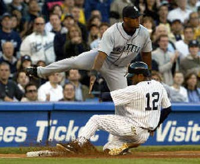 
Tony Womack slides safely under Adrian Beltre on Gary Sheffield's first-inning single in Yankees' 4-3 win.  
 (Associated Press / The Spokesman-Review)