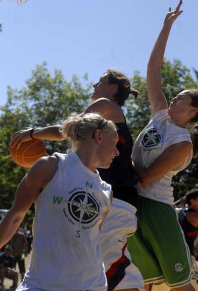 
Tomato Street's Ashley Anderson drives for the basket between Cricket's Ashly Jamison, left, and Abby Johnson. Tomato Street repeated as the Women's Elite Division champion on Sunday. 
 (J. BART RAYNIAK / The Spokesman-Review)
