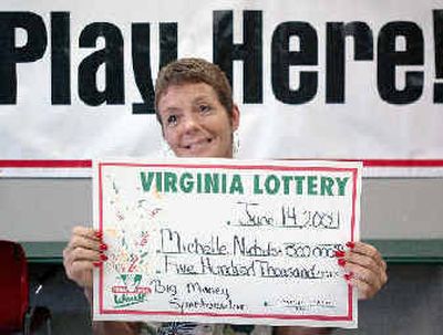
Mitzi Nichols holds up her token check for the media representing her $500,000 win in the Virginia Lottery on Tuesday at the lottery office in Hampton, Va. Mitzi Nichols holds up her token check for the media representing her $500,000 win in the Virginia Lottery on Tuesday at the lottery office in Hampton, Va. 
 (Associated PressAssociated Press / The Spokesman-Review)