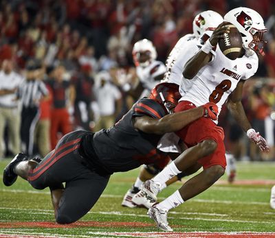 Louisville quarterback Lamar Jackson (8) is sacked by Houston defensive tackle Ed Oliver during the first half of an NCAA college football game, Thursday, Nov. 17, 2016, in Houston. (Eric Christian Smith / Associated Press)