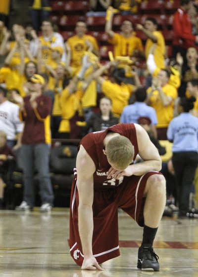 Washington State's Abe Lodwick kneels on the court after missing a  game-winning shot at the end of the second half of an NCAA college basketball game against Arizona State. (Ross Franklin / Associated Press)