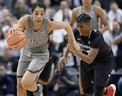 Connecticut's Gabby Williams, left, is pursued by Cincinnati's Maya Benham, right, during the second half of an NCAA college basketball game, Sunday, Feb. 4, 2018, in Hartford, Conn. (Jessica Hill / Associated Press)