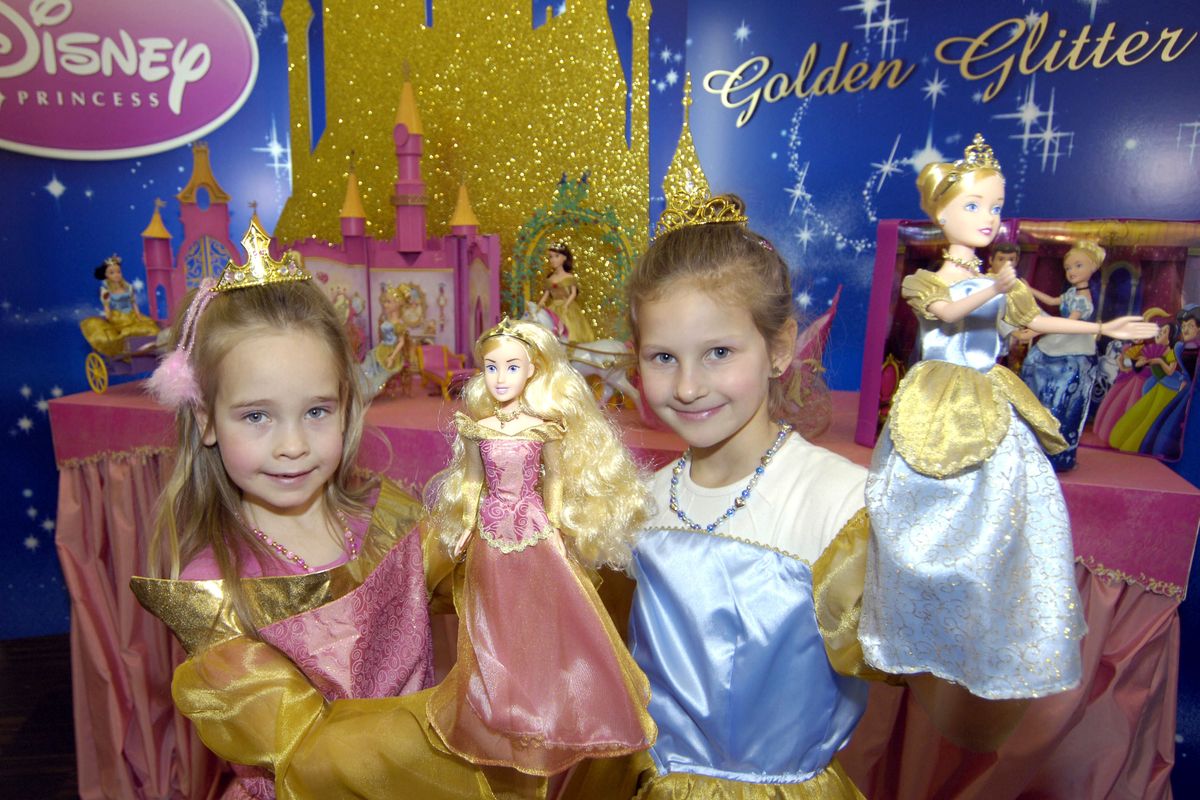 Fans of the Disney Princess line pose with their dolls at a booth of the toy producer Simba Toys. Mattel’s line of 12-inch dolls based on Disney princesses including Cinderella and Rapunzel have been strong sellers and are still among the top five U.S. doll lines in 2013. (Associated Press)