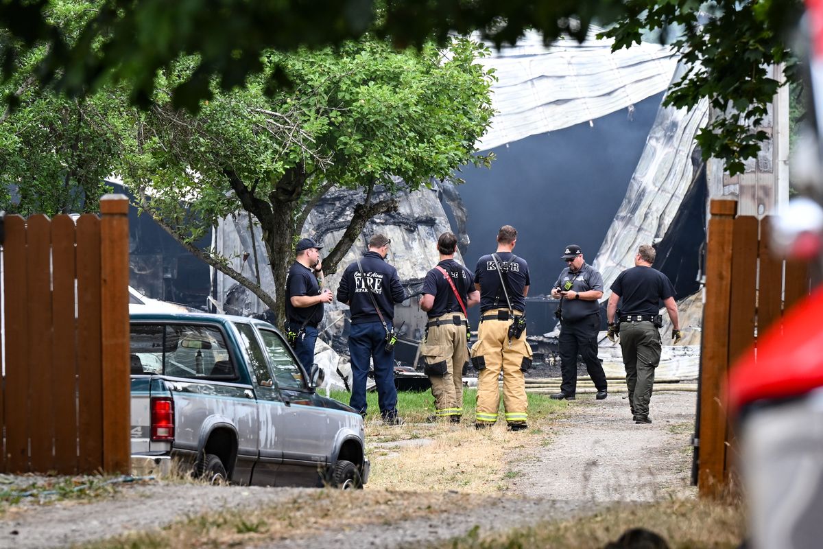 Firefighters investigate the scene of a fatal fire Tuesday on the 3000 block of North 15th Street in Coeur d’Alene. (Tyler Tjomsland/The Spokesman-Review)