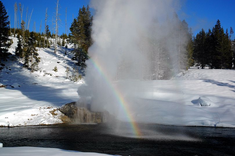 The River Side Geyser next to the Firehole River in Yellowstone National Park can be found at the end  of a rainbow. The geyser can be reached by skis or snowshoes from Snow Lodge.