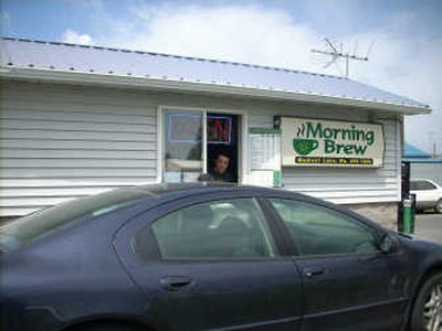 
Brian Perry, one of the owners of Morning Brew in Medical Lake, serves up some coffee to customer Ernest Albin.
 (Lisa Leinberger / The Spokesman-Review)