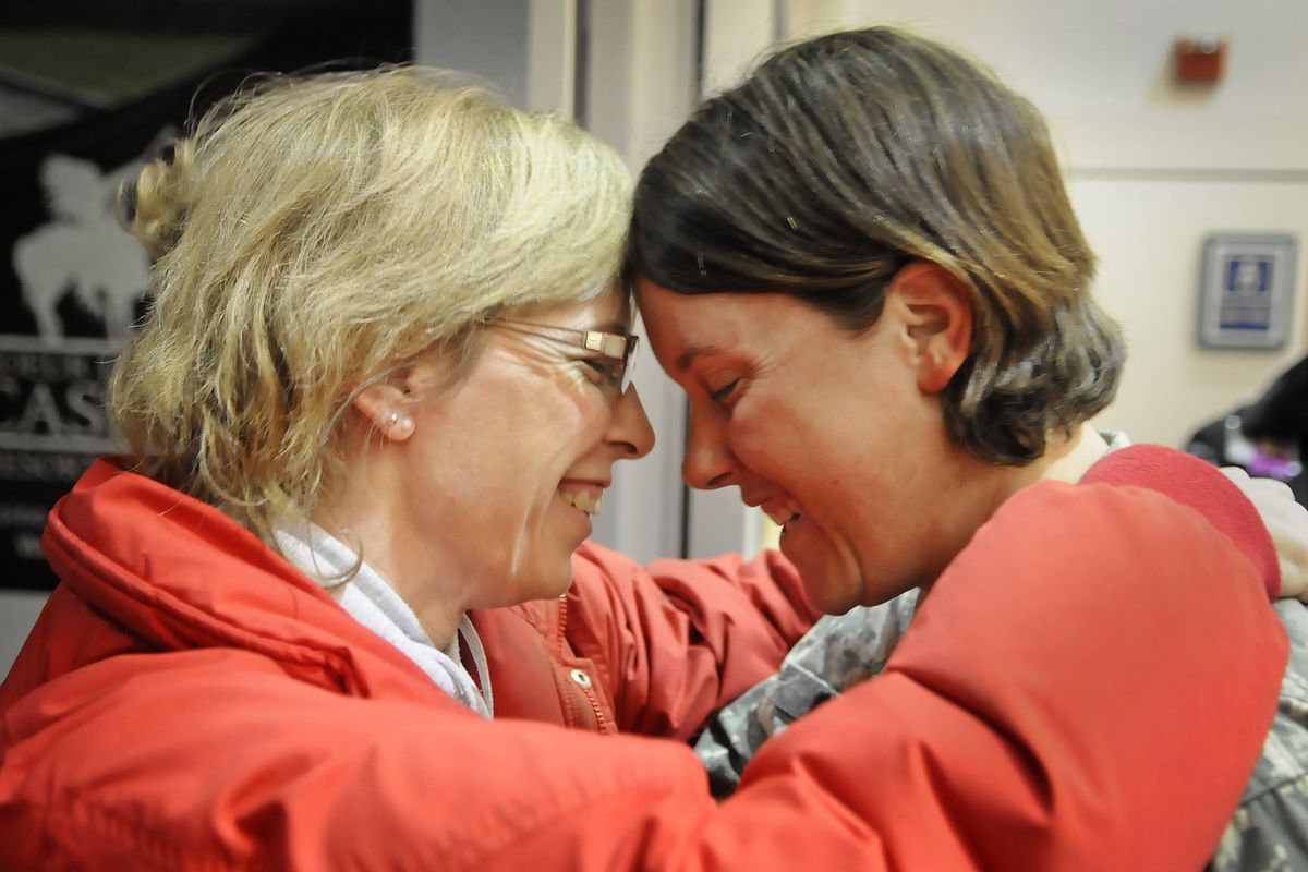 Ruth Briggs, left, is the first to welcome her daughter, U.S. Army medic Blythe Briggs, home from Iraq at Spokane International Airport early Saturday morning. Briggs was among the last U.S. troops to leave the country.