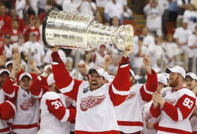 
Detroit's Dallas Drake, enjoying his first title in 14 NHL seasons, hoists the Red Wings' fourth Stanley Cup in the last 11 years. Associated Press
 (Associated Press / The Spokesman-Review)