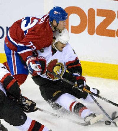 
 Canadiens' Michael Ryder takes down  Senators' Peter Schaefer. 
 (Associated Press / The Spokesman-Review)