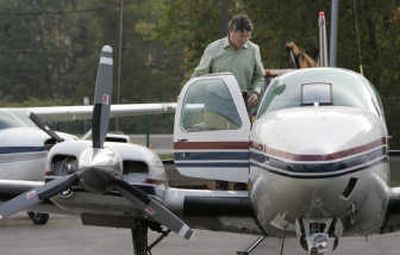 
Andy Davidson climbs into the cockpit of his twin-engine plane Oct. 9 in New Jersey.
 (Associated Press / The Spokesman-Review)
