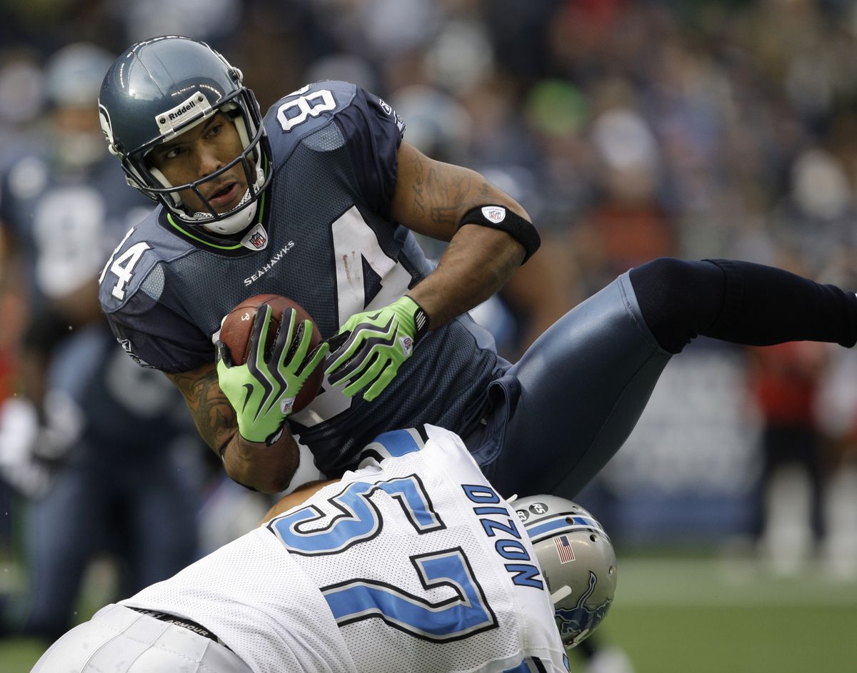 Detroit’s Jordon Dizon tackles Seahawks wide receiver T.J. Houshmandzadeh during the first half. (Associated Press / The Spokesman-Review)
