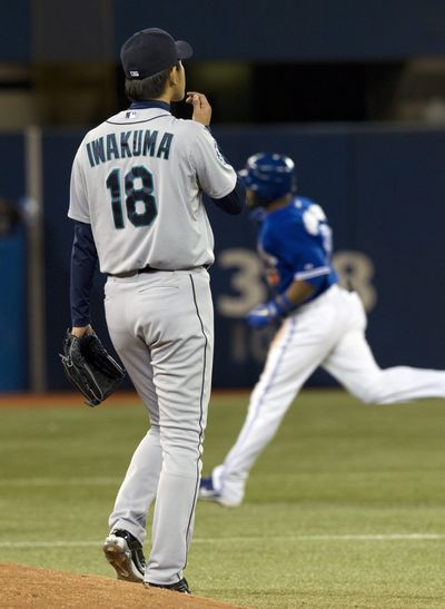 Seattle Mariners pitcher Hisashi Iwakuma watches as Toronto Blue Jays Edwin Encarnacion rounds the bases on his grand slam during 8th inning A.L. action in Toronto on April 28, 2012. (Associated Press)