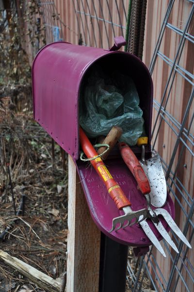 Garden hacks can make gardening easier and save time. This repurposed mailbox holds small tools, twine, gloves, plastic bags and stakes that are within easy reach of a quick garden project.  (Pat Munts/For The Spokesman-Review)