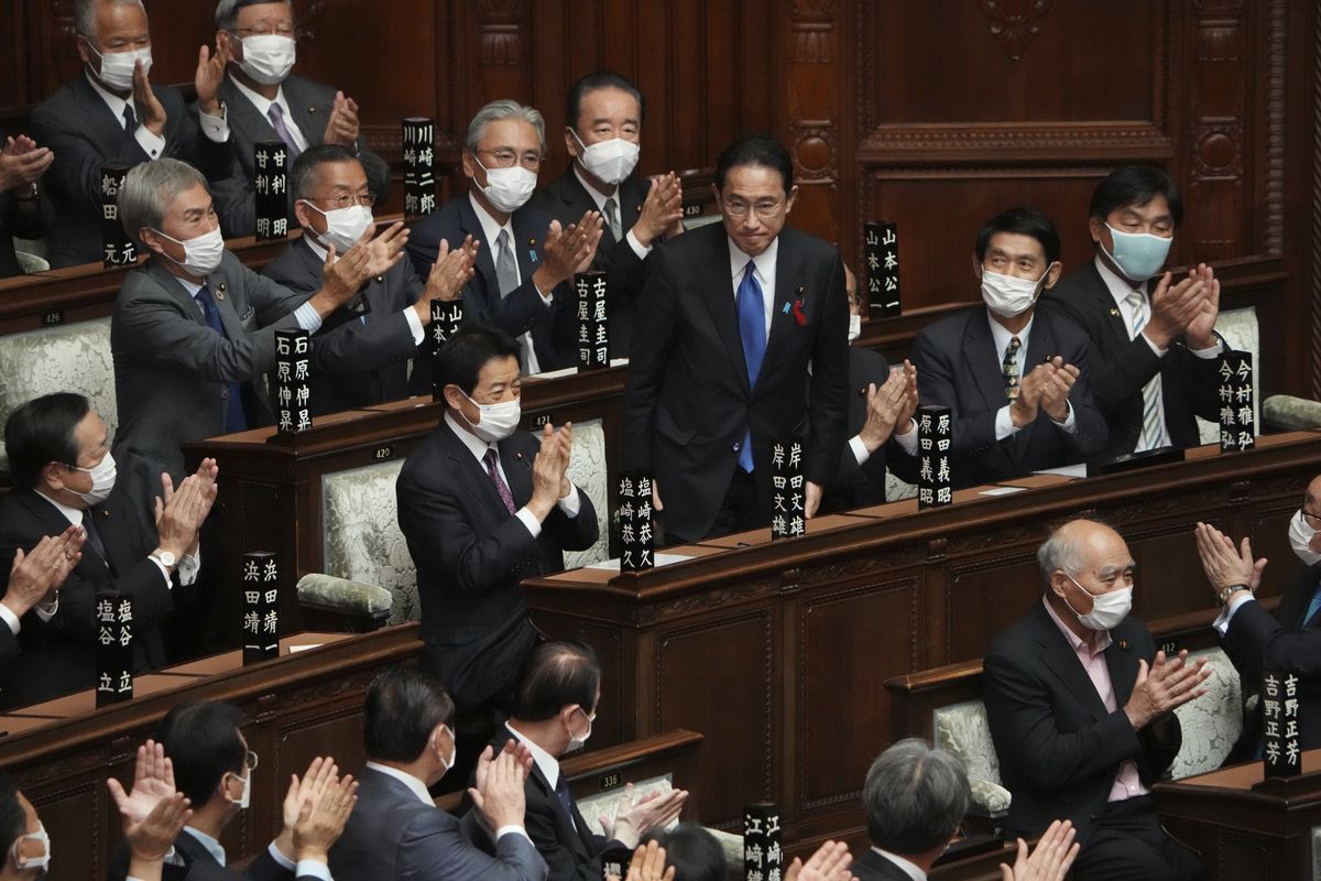 Fumio Kishida, center, is applauded after being elected as Japan