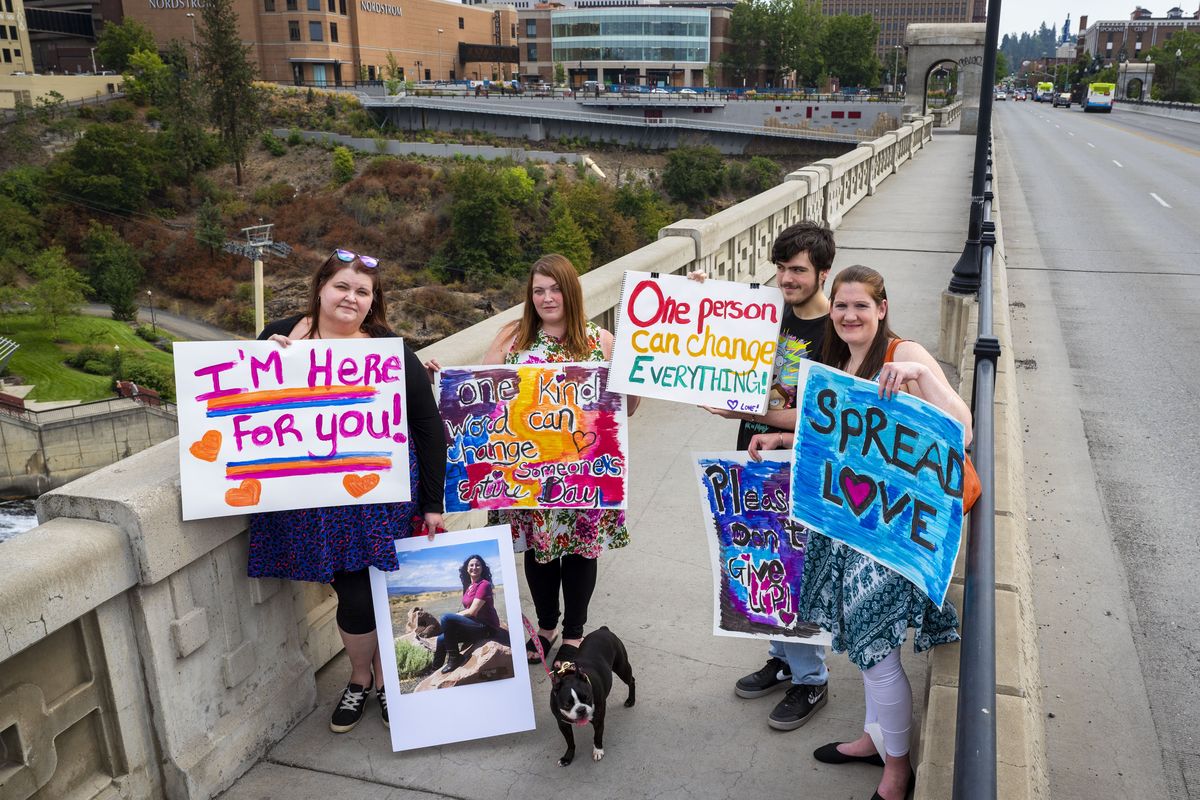 Left to right: Kat McKenna, Toni Cornell, Calub Lynch and Jodi Rivas hold signs they plan to show at the Monroe Street Bridge mental health awareness gathering on the bridge this Sunday. After seeing recent news reports of people attempting suicide from the bridge, the group felt a call to action.  (Colin Mulvany/THE SPOKESMAN-REVI)