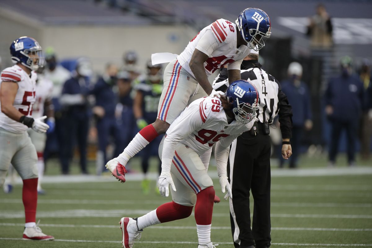 Giants defensive end Leonard Williams, below, celebrates with linebacker Tae Crowder after Williams sacked Seahawks quarterback Russell Wilson.  (Associated Press)