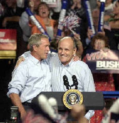 
President Bush, left, and former New York City Mayor Rudy Giuliani hug during a rally Thursday in Las Cruces, N.M.
 (Associated Press / The Spokesman-Review)