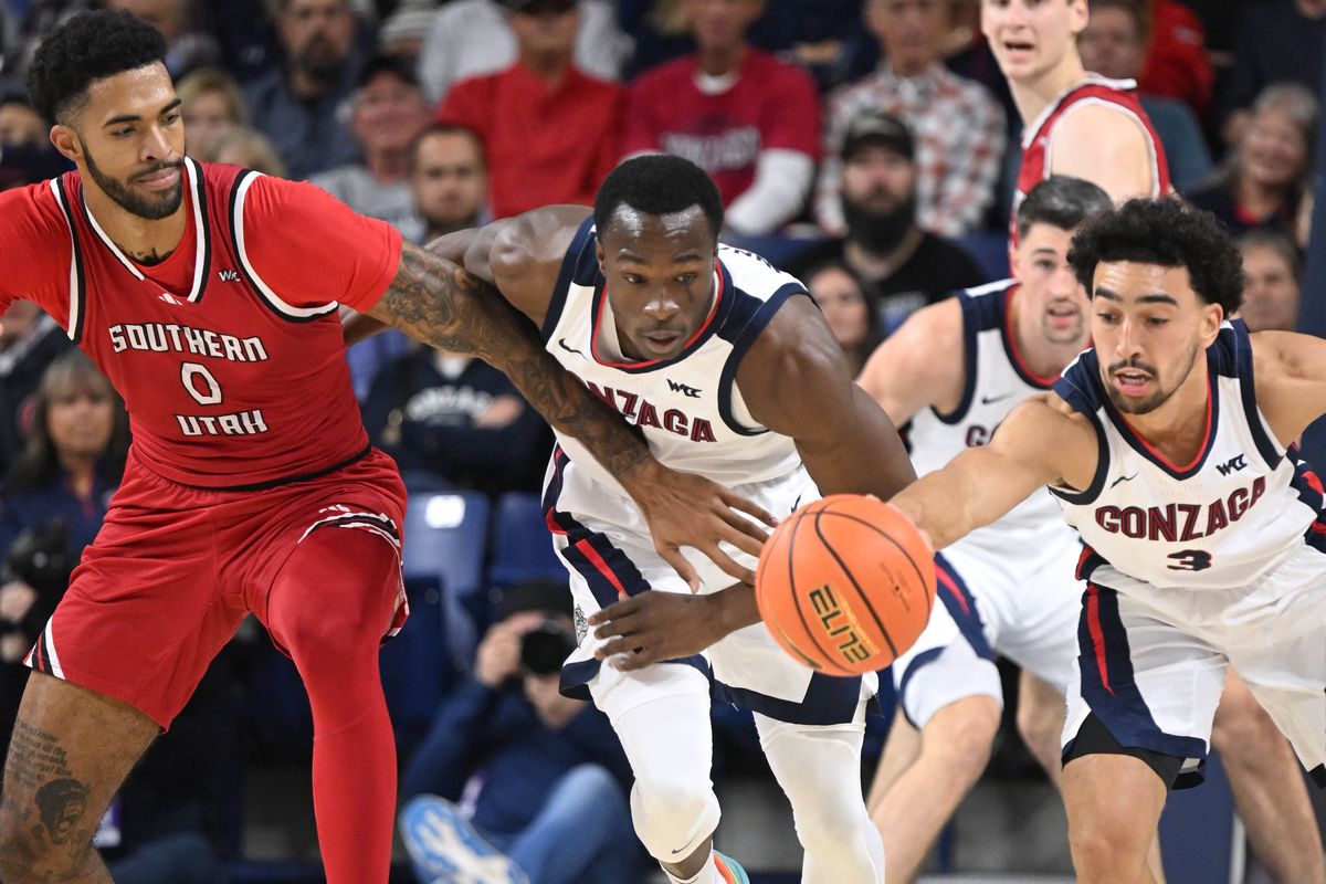 Southern Utah center Isaiah Cottrell (0) Gonzaga forward Emmanuel Innocenti (5) and guard Braeden Smith (3) chase after a loose ball during the first half of a NCAA college basketball game, Monday, Nov. 17, 2025, in the McCarthey Athletic Center.  (COLIN MULVANY/THE SPOKESMAN-REVI)