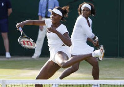 Venus, left, and Serena Williams won their doubles match on Monday in addition to their singles matches.Associated Press
 (Associated Press / The Spokesman-Review)