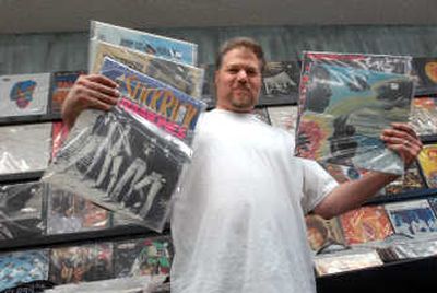 
Tony Brown of Unified Groove Merchants holds up some examples of what he carries: mainstream, vintage, folk, jazz and indie music on 12-inch vinyl. 