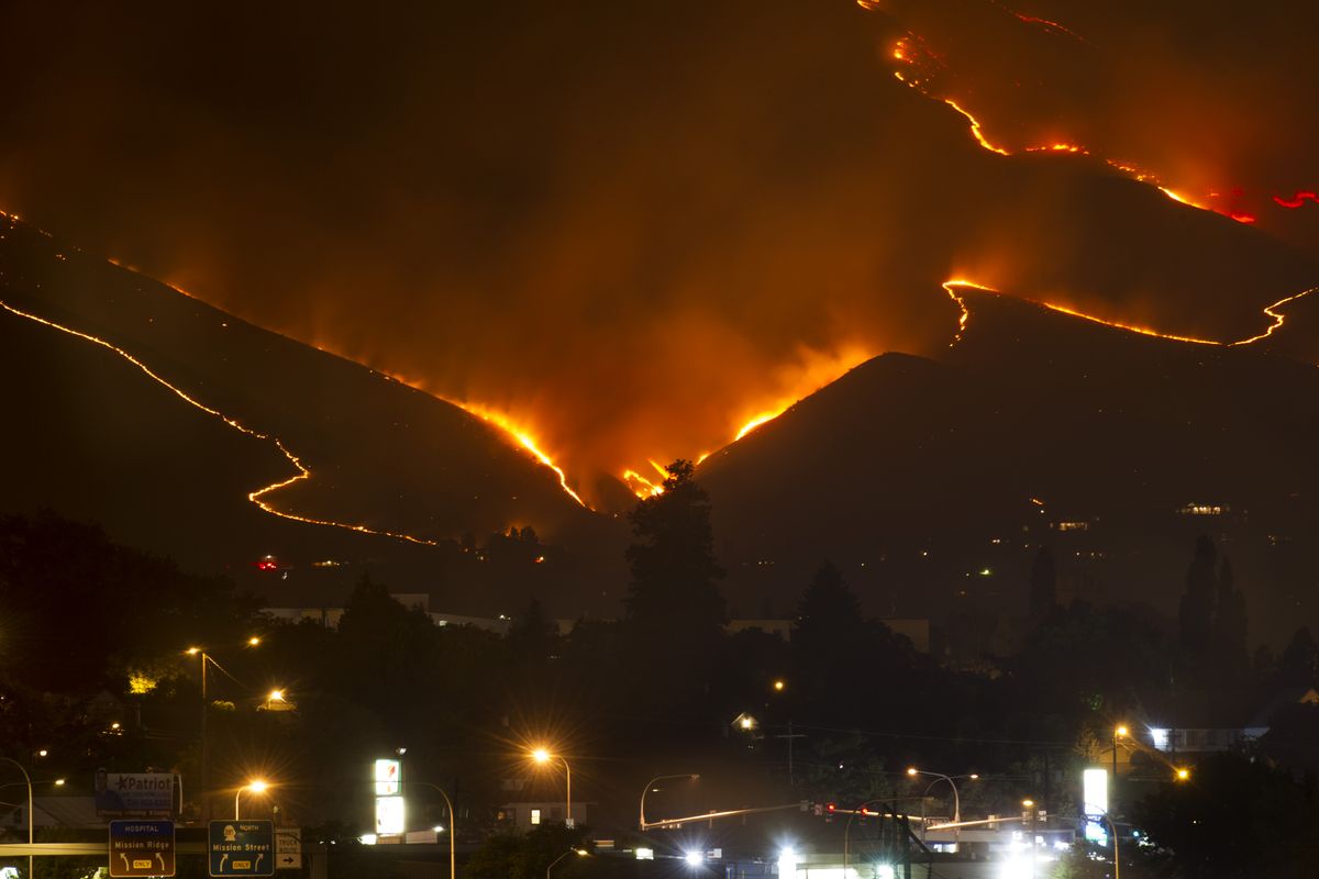 The Sleepy Hollow Fire is seen engulfing a hillside west of Wenatchee and threatening structures at approximately 3 A.M. on Monday, Jun 29, 2015, in Wenatchee, Wash.  (Tyler Tjomsland)