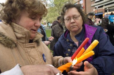 
Kathleen Paris,  left, and Carrole Brathovd  light candles at a vigil Monday  to remember Otto Zehm.  
 (Colin Mulvany / The Spokesman-Review)
