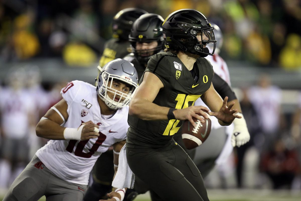 Oregon quarterback Justin Herbert warms up before the the team's NCAA  college football game against Arizona on Saturday, Nov. 18, 2017, in  Eugene, Ore. Herbert has been out with an injury. (AP