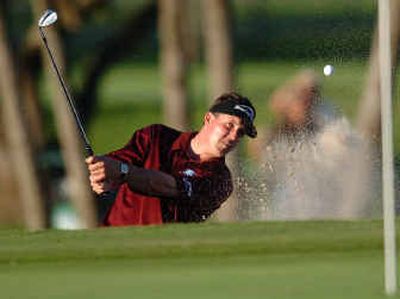 
Phil Mickelson hits out of a sand trap on the 14th green during the third round of the Ford Championship at Doral Saturday.
 (Associated Press / The Spokesman-Review)