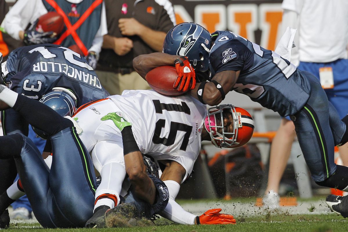 Browns receiver Greg Little (15) is hit by Seahawks’ Walter Thurmond, right, and Kam Chancellor (31) after a second-quarter catch. (Associated Press)