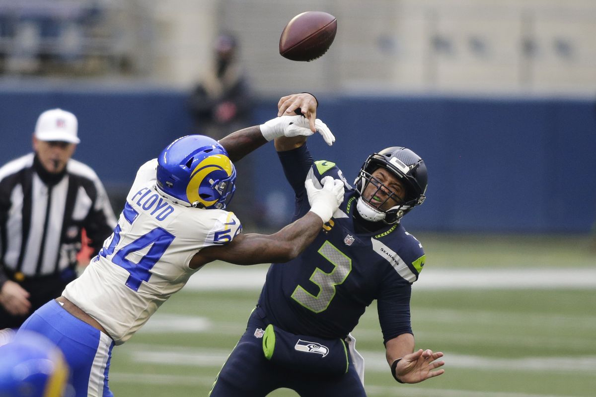 Los Angeles Rams outside linebacker Leonard Floyd (54) knocks the ball away as Seattle Seahawks quarterback Russell Wilson tries to pass during the first half of an NFL wild-card playoff football game, Saturday, Jan. 9, 2021, in Seattle.  (Associated Press)