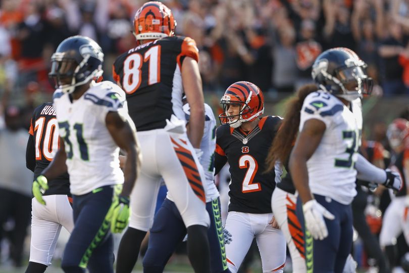 Cincinnati Bengals kicker Mike Nugent (2) celebrates after booting the winning field goal in overtime of an NFL football game against the Seattle Seahawks, Sunday, Oct. 11, 2015, in Cincinnati. The Bengals won 27-24. (Gary Landers / Associated Press)