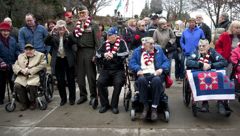 In this Dec. 7, 2014, SR file photo, Pearl Harbor Survivors Association members from left, Bud Garvin, in wheelchair, Ray Garland, in uniform, Clyde Buteau, in a walker, Charlie Boyer, wheelchair, and Sid Kennedy, wheelchair, gather before the newly-installed memorial stone before a ceremony at the Spokane Veterans Memorial Arena, to commemorate the 73rd anniversary of the attack that began America's involvement into WWII. (Dan Pelle/SR photo)