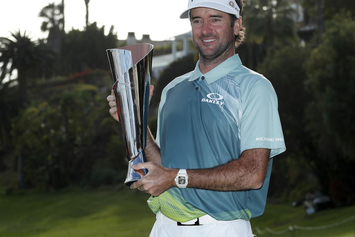 Bubba Watson poses with his trophy on the 18th green after winning the Genesis Open golf tournament at Riviera Country Club on Sunday, Feb. 18, 2018, in the Pacific Palisades area of Los Angeles. (Ryan Kang / Associated Press)