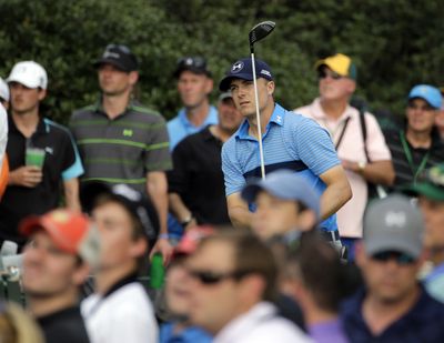 Masters first-round leader Jordan Spieth follows the flight of his tee shot on the 15th hole Thursday at Augusta, Georgia. (Associated Press)