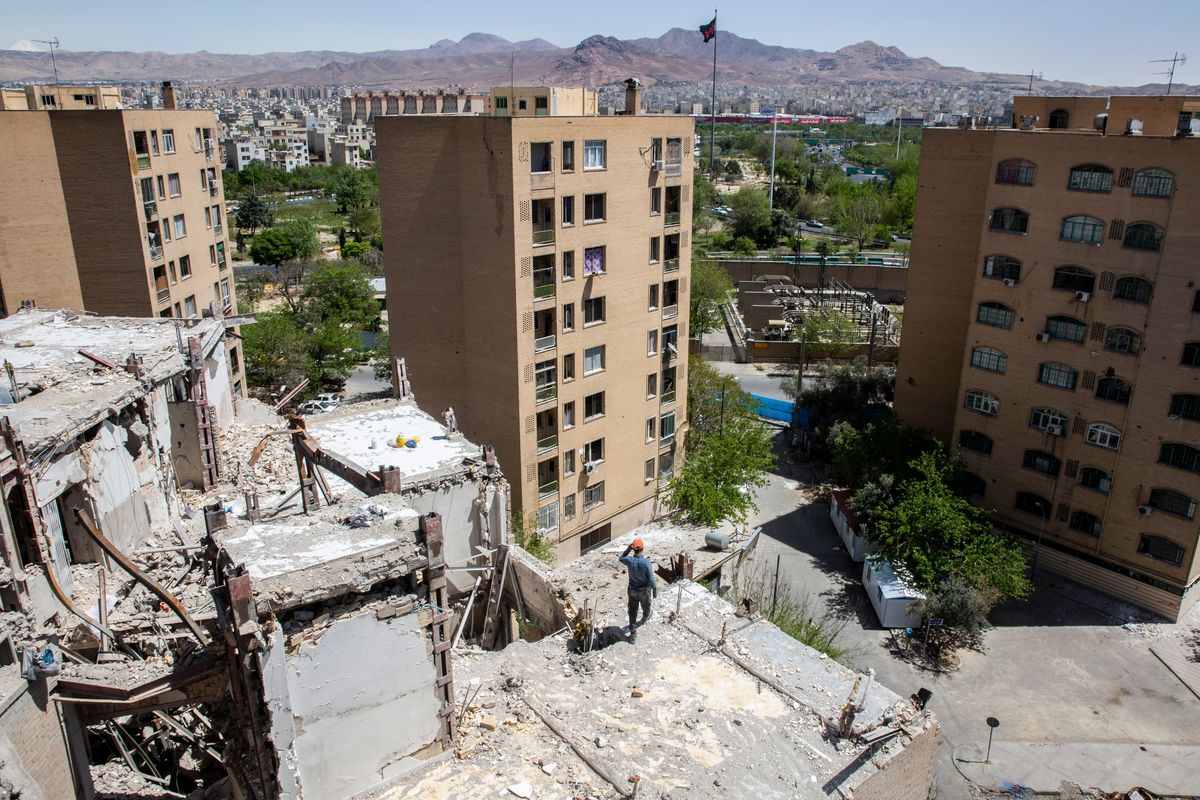 Construction workers at a residential building that was targeted earlier in the conflict by U.S.-Israeli airstrikes on Tuesday in Tehran, Iran. Fighting continued in southern Lebanon between Israel and Iran-backed Hezbollah, even as Israeli and Lebanese diplomats met in Washington. The war in Lebanon has threatened to undermine the U.S.-Iran cease-fire. (New York Times )