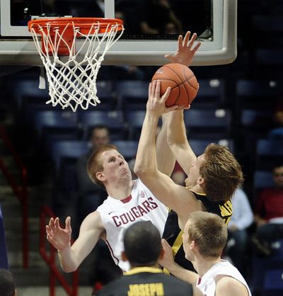 Brock Motum of WSU contests a shot and gets a partial block in the second half against Oregon. (Christopher Anderson)